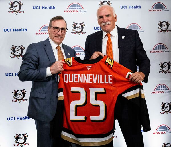 Anaheim Ducks general manager Pat Verbeek, left, and new head coach Joel Quenneville pose with jersey during an NHL hockey press conference in Anaheim, Calif., Thursday, May 8, 2025. (Paul Bersebach/The Orange County Register via AP)