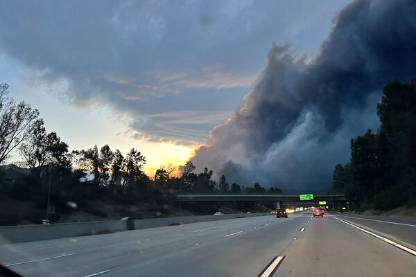 Thick smoke from the Eaton Fire is seen as Ryan Pearson, a Los Angeles-based entertainment video editor for The Associated Press, drives to his neighborhood in Altadena, Calif., Wednesday, Jan. 8, 2025. (AP Photo/Ryan Pearson)