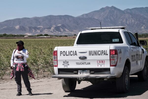 The relative of a missing person waits to enter Izaguirre Ranch to see if any of the skeletal remains discovered here are identifiable in Teuchitlan, Jalisco state, Mexico, Thursday, March 13, 2025. (AP Photo/Alejandra Leyva)