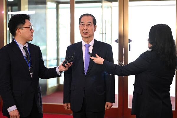 South Korean Prime Minister Han Duck-soo, center, speaks to the media as he arrives at the Government Complex in Seoul Monday, March 24, 2025, after the Constitutional Court dismissed the impeachment of the prime minister. (Jung Yeon-je/Pool Photo via AP)