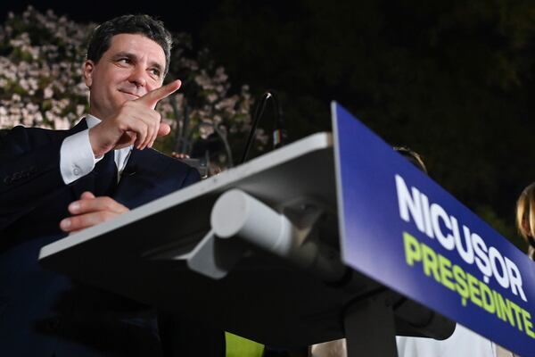 Presidential candidate Nicusor Dan gestures as he addresses supporters after polls closed for the first round of the country's presidential election redo in Bucharest, Romania, Sunday, May 4, 2025. (AP Photo/Eduard Vinatoru)