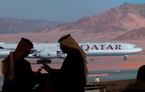 FILE - Journalists chat as video of a plane is shown on a screen while landing at at Al Ula airport in Saudi Arabia, Jan. 5, 2021. (AP Photo/Amr Nabil, file)