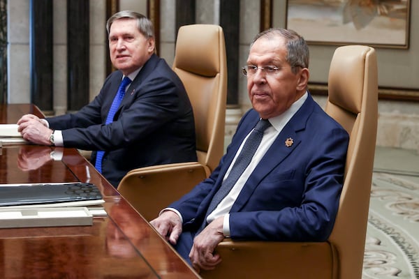 Russian Foreign Minister Sergei Lavrov, right, sits next to Russian President Vladimir Putin's foreign policy advisor Yuri Ushakov during a meeting with U.S. Secretary of State Marco Rubio, U.S. National Security Advisor Mike Waltz and U.S. Middle East envoy Steve Witkoff, Saudi Foreign Minister Prince Faisal bin Farhan Al Saud and Saudi National Security Advisor Mosaad bin Mohammad Al-Aiban, at Diriyah Palace, in Riyadh, Saudi Arabia, Tuesday, Feb. 18, 2025. (Evelyn Hockstein/Pool Photo via AP)