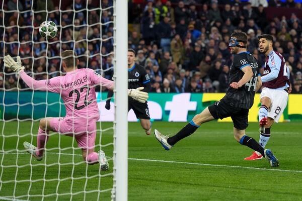 Aston Villa's Marco Asensio, right, scores the opening goal during the Champions League round of 16 second leg soccer match between Aston Villa and Club Brugge at the Villa Park stadium in Birmingham, England, Wednesday, March 12, 2025. (AP Photo/Darren Staples)