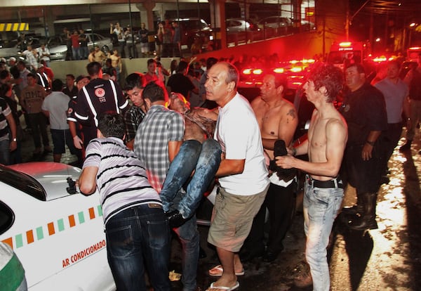 FILE - A victim of a fire in a club is carried in Santa Maria city, Rio Grande do Sul state, Brazil, early Sunday, Jan. 27, 2013. (AP Photo/Deivid Dutra/Agencia Freelancer, File)