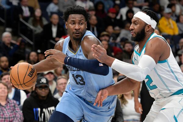 Memphis Grizzlies forward Jaren Jackson Jr. handles the ball against Charlotte Hornets forward Josh Okogie (12) in the first half of an NBA basketball game, Wednesday, Jan. 22, 2025, in Memphis, Tenn. (AP Photo/Brandon Dill)