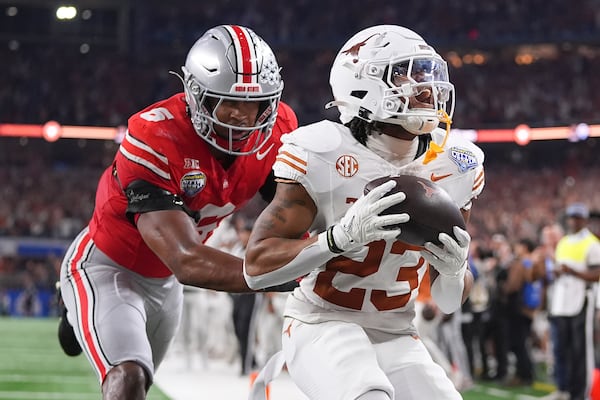 Texas running back Jaydon Blue (23) reacts after catching a touchdown pass against Ohio State safety Sonny Styles (6) during the first half of the Cotton Bowl College Football Playoff semifinal game, Friday, Jan. 10, 2025, in Arlington, Texas. (AP Photo/Julio Cortez)