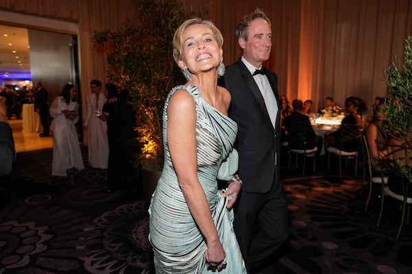 Sharon Stone, left, and Jim Osborne arrive at the 82nd Golden Globes on Sunday, Jan. 5, 2025, at the Beverly Hilton in Beverly Hills, Calif. (AP Photo/Chris Pizzello)