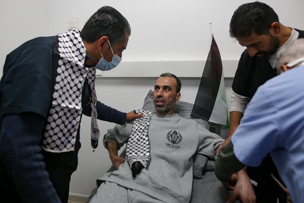 A freed Palestinian prisoner sits at a medical center as he arrives in the Gaza Strip after being released from an Israeli prison following a ceasefire agreement between Hamas and Israel in Khan Younis, Thursday, Jan. 30, 2025. (AP Photo/Jehad Alshrafi)