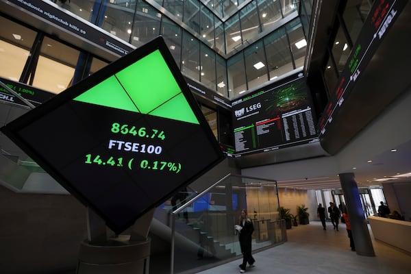 FTSE market information is displayed inside the London Stock Exchange, in the City of London, Monday, March 17, 2025. (AP Photo/Kin Cheung)