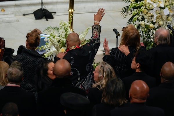 Attendees sing "How Great Thou Art" during a ceremony in celebration of Roberta Flack's life at The Abyssinian Baptist Church on Monday, March 10, 2025, in New York. (AP Photo/Richard Drew)