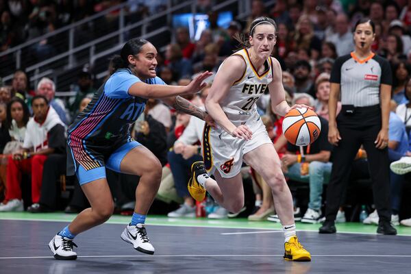 Indiana Fever guard Caitlin Clark (22) drives to the basket against Atlanta Dream guard Te-Hina Paopao, left, in the first half of an WNBA basketball game, Thursday, May, 22, 2025, in Atlanta. (AP Photo/Colin Hubbard)