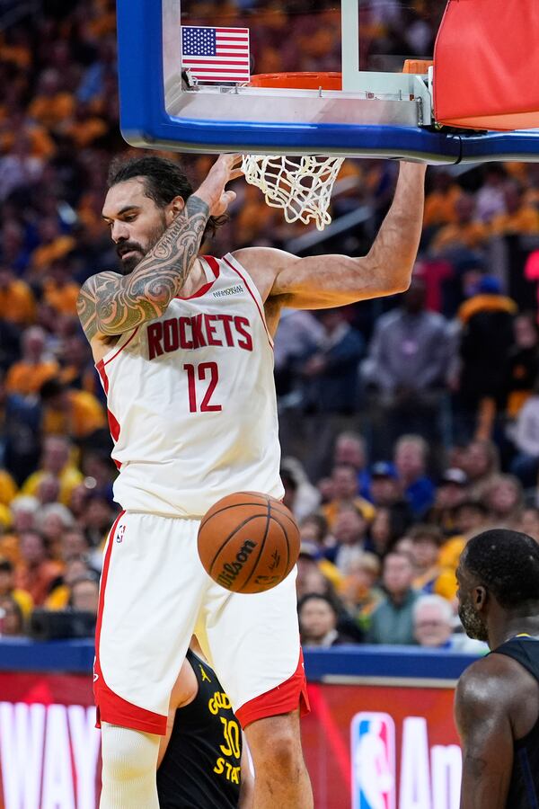 Houston Rockets center Steven Adams (12) dunks in front of Golden State Warriors forward Draymond Green during the second half of Game 6 of an NBA basketball first-round playoff series Friday, May 2, 2025, in San Francisco. (AP Photo/Godofredo A. Vásquez)