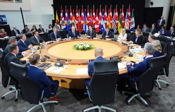 Canada Prime Minister Justin Trudeau, back center, premiers and cabinet ministers attend the first ministers meeting in Ottawa on Wednesday, Jan. 15, 2025. (Sean Kilpatrick/The Canadian Press via AP)