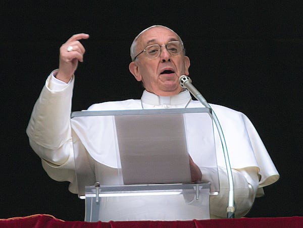 FILE - Pope Francis gestures on the first Sunday window appearance of his papacy to pray the Angelus and bless the faithful gathered in St. Peter's Square at the Vatican, Sunday, March 17, 2013. (AP Photo/Domenico Stinellis, File)