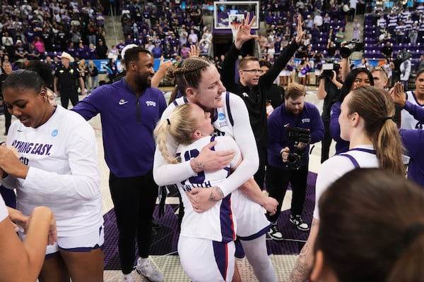 TCU's Hailey Van Lith (10) and Sedona Prince, center right, celebrate with the team after their win over Louisville in the second round of the NCAA college basketball tournament in Fort Worth, Texas, Sunday, March 23, 2025. (AP Photo/Tony Gutierrez)