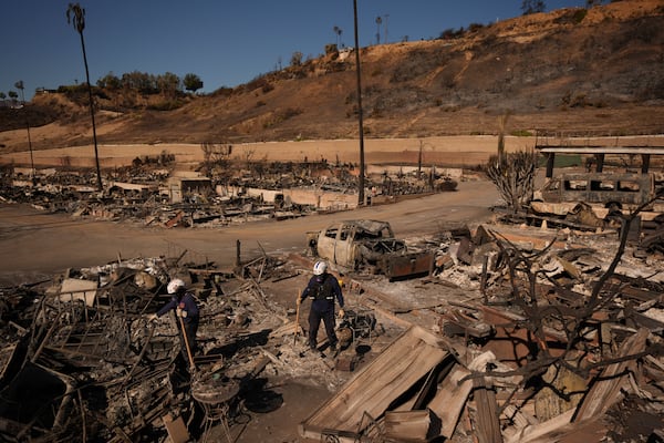 Search and rescue crew inspect a mobile home park destroyed by the Palisades Fire in Palisades, Calif. is seen, Wednesday, Jan. 15, 2025. (AP Photo/Jae C. Hong)