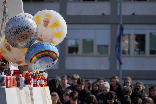 Balloons with pictures of Pope Francis are seen outside the Agostino Gemelli Polyclinic in Rome, Sunday, Feb. 23, 2025, where the Pontiff is hospitalized since Feb. 14. (AP Photo/Gregorio Borgia)