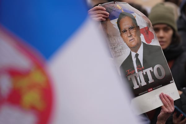 A woman holds picture of the late Yugoslav communist president Josip Broz Tito during a general strike after more than two months of protests over the collapse of a concrete canopy that killed 15 people more than two months ago, in Belgrade, Serbia, Friday, Jan. 24, 2025. (AP Photo/Darko Vojinovic)