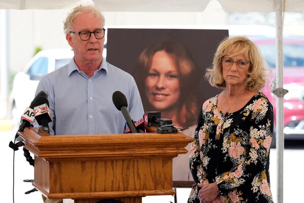 Mike Robirds, left, speaks as his sister, Terri Osborne, right, listens outside Riverbend Maximum Security Institution after the execution of Oscar Smith Thursday, May 22, 2025, in Nashville, Tenn. Robirds and Osborne are siblings of Judy Robirds, shown in the photograph between them, who was murdered along with her sons by Oscar Smith in 1989. (AP Photo/Mark Humphrey)
