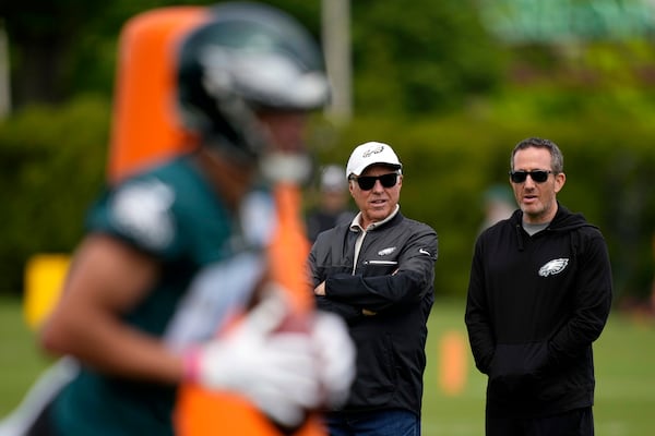 FILE - Philadelphia Eagles' Howie Roseman, right, and Jeffrey Lurie watch drills during rookie minicamp at the NFL football team's training facility, Friday, May 3, 2024, in Philadelphia. (AP Photo/Matt Slocum, File)