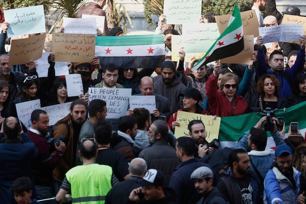 Activists demonstrate against violence in the coastal region of Damascus, Syria, Sunday, March 9, 2025. (AP Photo/Omar Sanadiki)