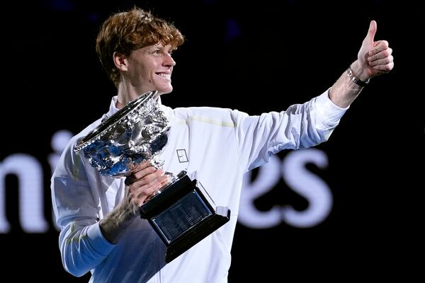 Jannik Sinner of Italy gestures as he carries the Norman Brookes Challenge Cup after defeating Alexander Zverev of Germany in the men's singles final at the Australian Open tennis championship in Melbourne, Australia, Sunday, Jan. 26, 2025. (AP Photo/Asanka Brendon Ratnayake)