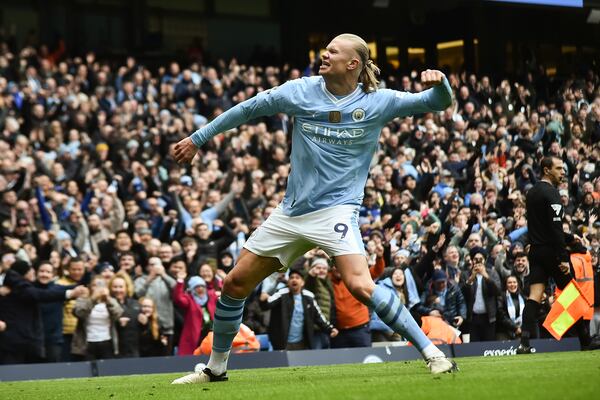 FILE -Manchester City's Erling Haaland celebrates with after scoring his side's second goal during the English Premier League soccer match between Manchester City and and Everton, at the Etihad stadium in Manchester, England, Feb. 10, 2024. (AP Photo/Rui Viera, File)