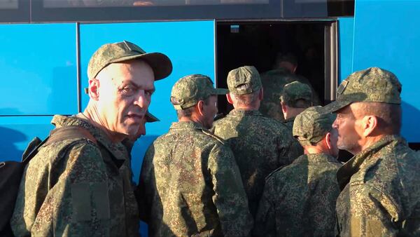 In this photo taken from video released by Russian Defense Ministry Press Service on Saturday, May 24, 2025, Russian servicemen board a bus upon arrival to Chkalovsky airport, outside Moscow, Russia, after returning from captivity by a POWs exchange between Russia and Ukraine. (Russian Defense Ministry Press Service photo via AP)