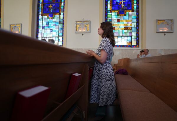 Zoey Stapleton, a current postulant at the Franciscan Sisters T.O.R., of Penance of the Sorrowful Mother, kneels to pray during Mass at St. Joan of Arc Catholic Church in Hershey, Pa., Wednesday, July 3, 2024. (AP Photo/Jessie Wardarski)