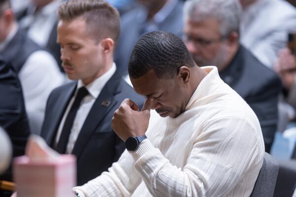 Wichita, Kan., city council member Brandon Johnson grieves during a prayer vigil in Wichita, Kan., on Thursday, Jan. 30, 2025, for those affected by the crash of American Airlines flight 5342 in Washington the day before. (AP Photo/Travis Heying)