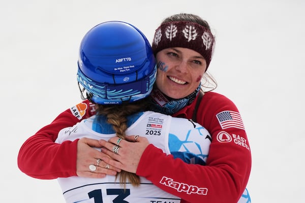 United States' Breezy Johnson, right, hugs teammate. United States' Mikaela Shiffrin at the finish area of a slalom run of a women's team combined event, at the Alpine Ski World Championships, in Saalbach-Hinterglemm, Austria, Tuesday, Feb. 11, 2025. (AP Photo/Giovanni Auletta)