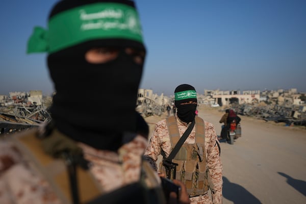 Hamas fighters prepare for the hand-over of Israeli and Thai hostages to the Red Cross in the south Gaza Strip town of Khan Younis, Thursday Jan. 30, 2025.(AP Photo/Abdel Kareem Hana)