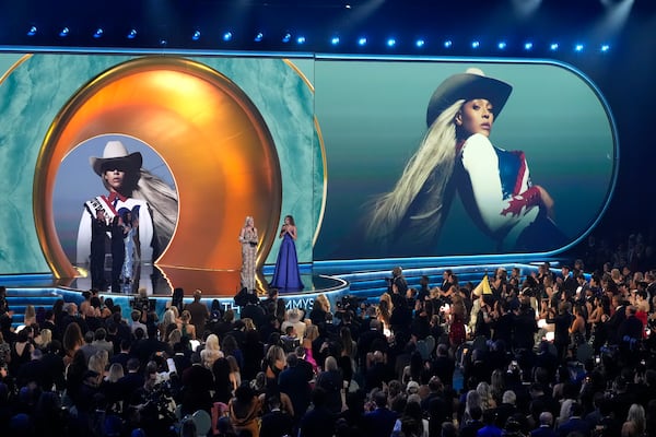 Beyonce accepts the award for album of the year for "COWBOY CARTER during the 67th annual Grammy Awards on Sunday, Feb. 2, 2025, in Los Angeles. Blue Ivy Carter looks on from right.(AP Photo/Chris Pizzello)