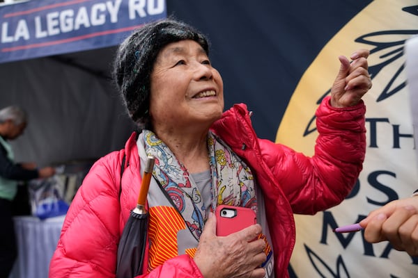 Masako Higuchi, 83, gathers with other runners ahead of the Los Angeles Marathon at the Lifestyle Expo at Dodger Stadium, Friday, March 14, 2025 in Los Angeles. (AP Photo/Damian Dovarganes)