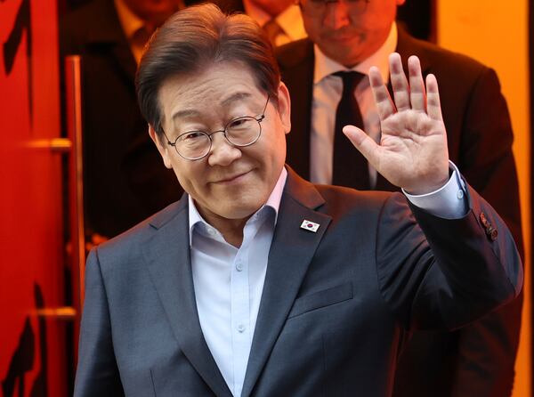 South Korea's Democratic Party presidential candidate Lee Jae-myung exits a meeting with delivery workers in Seoul, South Korea, Thursday, May 1, 2025. (Suh Myung-geon/Yonhap via AP)