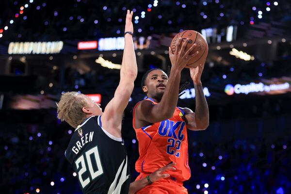 Oklahoma City Thunder guard Cason Wallace (22) shoots against Milwaukee Bucks guard AJ Green (20) during the first half of the championship game in the NBA Cup basketball tournament Tuesday, Dec. 17, 2024, in Las Vegas. (AP Photo/Ian Maule)