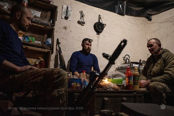 In this photo provided by Ukraine's 33rd Mechanised Brigade press service, servicemen prepare a festive dinner on Christmas Eve in a shelter on the frontline in the Dnipropetrovsk region, Ukraine, Tuesday, Dec. 24, 2024. (Volodymyr Petrov/Ukraine's 33rd Mechanised Brigade via AP)