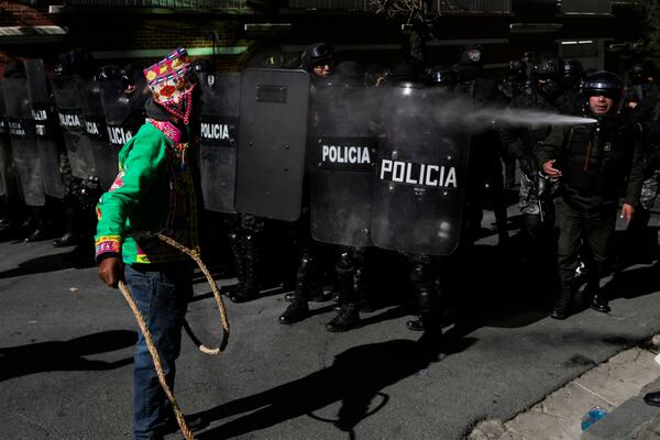 A supporter of former President Evo Morales confronts police during clashes near the offices of the Electoral Tribunal in La Paz, Bolivia, Friday, May 16, 2025. (AP Photo/Juan Karita)