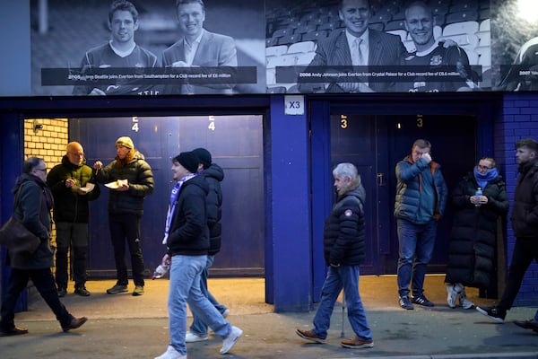 Fans walk outside of the Goodison Park stadium ahead of the English Premier League soccer match between Everton and Liverpool in Liverpool, England, Wednesday, Feb.12, 2025. (AP Photo/Dave Thompson)