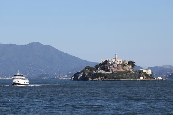 A tour boat is skippered past Alcatraz Island Monday, May 5, 2025, in San Francisco. (AP Photo/Jed Jacobsohn)