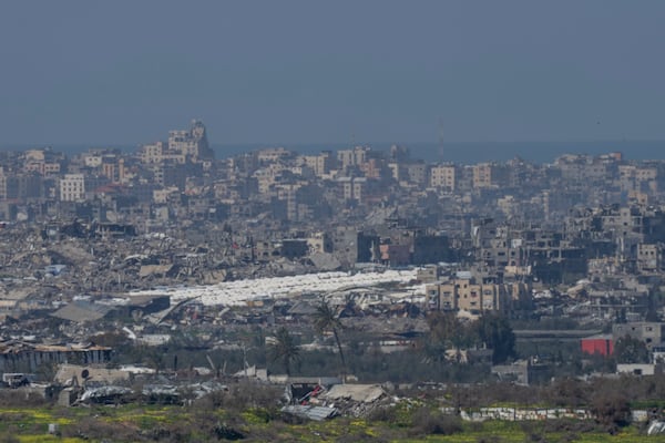 Tents are seen among the destroyed buildings in the Gaza Strip as seen from southern Israel, Tuesday, Feb. 25, 2025. (AP Photo/Ohad Zwigenberg)