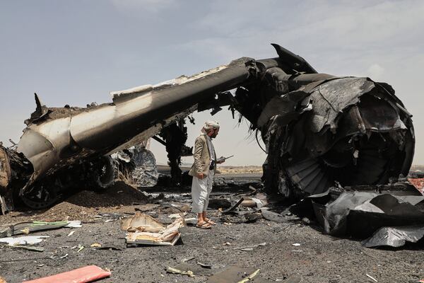 A Yemeni officer inspects the wreckage of a destroyed civilian aircraft following Israeli airstrikes on Sanaa International Airport in Sanaa, Yemen, Wednesday, May 7, 2025. (AP Photo/Osamah Abdulrahman)