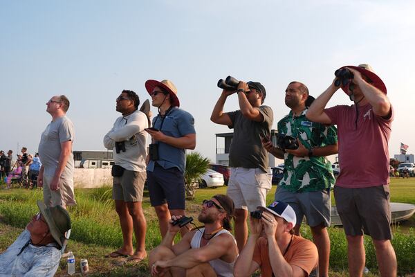 People watch as SpaceX's mega rocket Starship makes a test flight from Starbase, Texas, Tuesday, May 27, 2025. (AP Photo/Eric Gay)