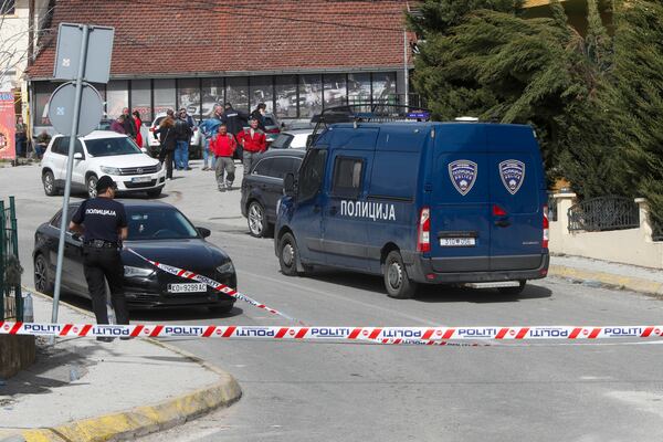 Police officers block a road near a nightclub after a massive fire in the town of Kocani, North Macedonia, Sunday, March 16, 2025. (AP Photo/Boris Grdanoski)