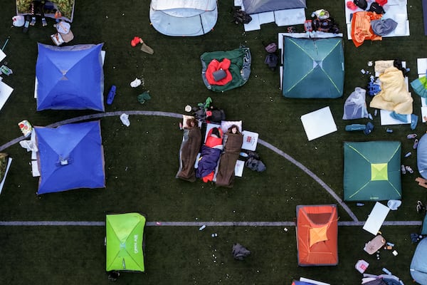 An aerial view of students sleeping in their tents on a soccer stadium as they take part in a march and protest over the collapse of a concrete canopy that killed 15 people more than two months ago, in Indjija, Serbia, Friday, Jan. 31, 2025. (AP Photo/Armin Durgut)