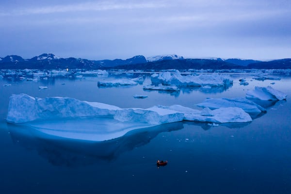 FILE - A boat navigates large icebergs near the town of Kulusuk, in eastern Greenland, on Aug. 15, 2019. (AP Photo/Felipe Dana, File)