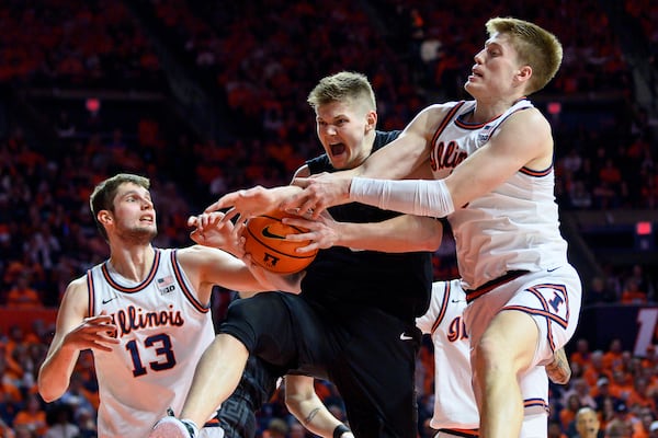 Michigan State's Jaxon Kohler battles for a rebound against Illinois' Tomislav Ivisic, left, and Ben Humrichous during the second half of an NCAA college basketball game Saturday, Feb. 15, 2025, in Champaign, Ill. (AP Photo/Craig Pessman)