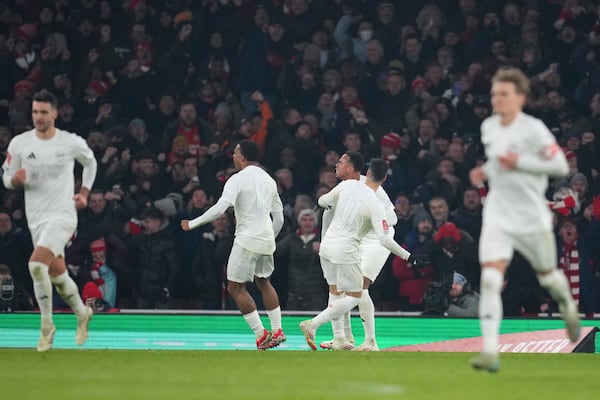 Arsenal's Gabriel celebrates with his teammates after scoring his side's opening goal during the English FA Cup soccer match between Arsenal and Manchester United at the Emirates stadium in London, Sunday, Jan. 12, 2025. (AP Photo/Kin Cheung)