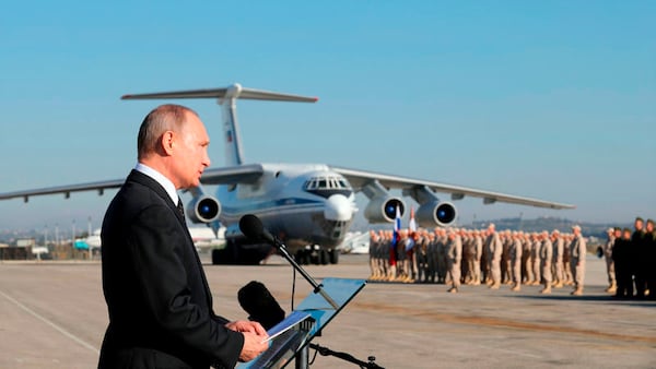 FILE - Russian President Vladimir Putin addresses troops at the Hemeimeem air base in Syria on Dec. 12, 2017. (Mikhail Klimentyev, Sputnik, Kremlin Pool Photo via AP, File)